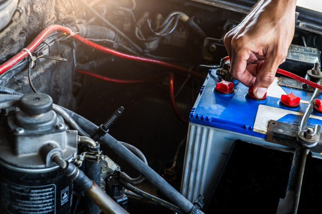 Hand worker service check car battery